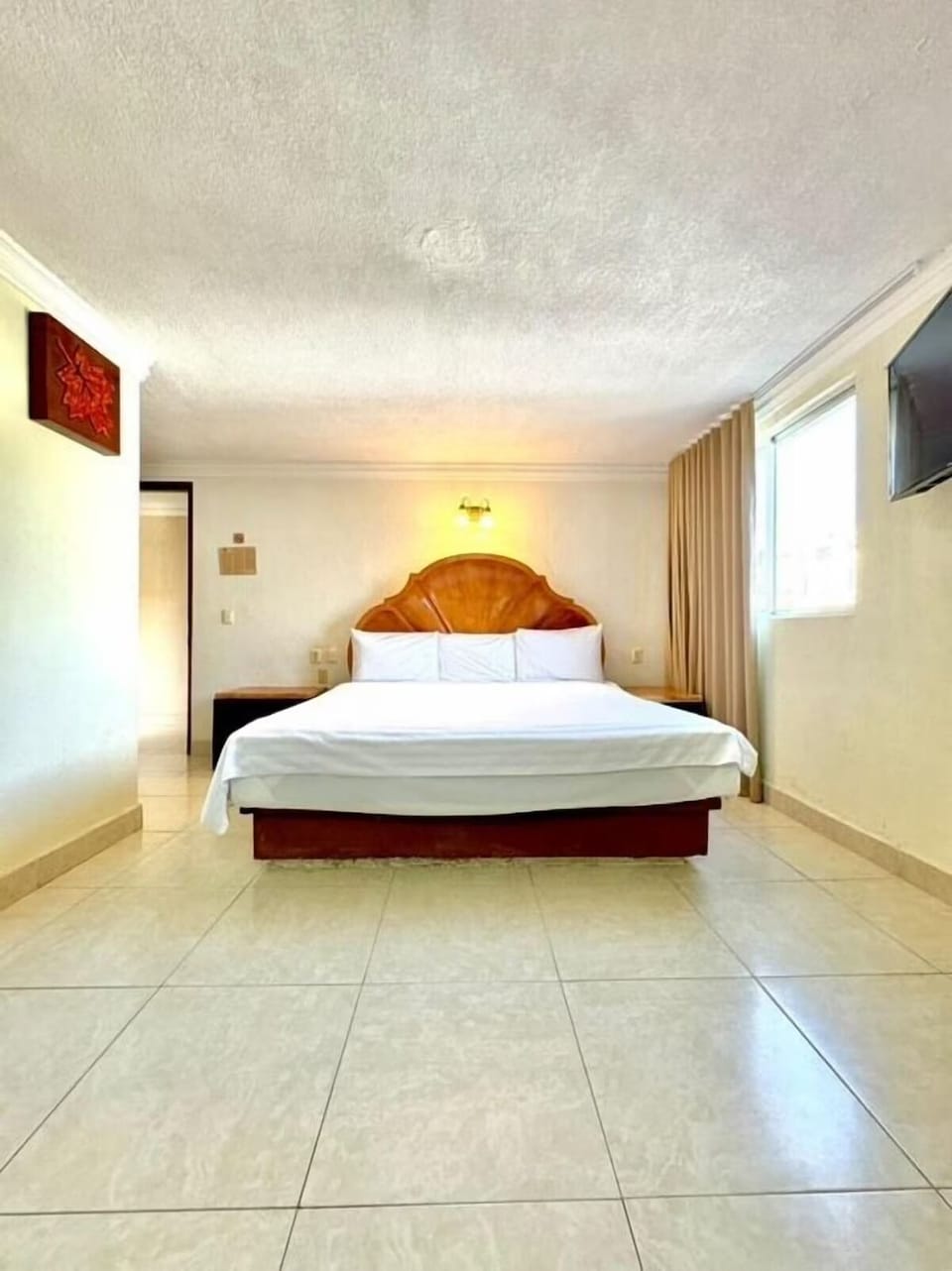 Unwind in a spacious king bed with calming natural light.