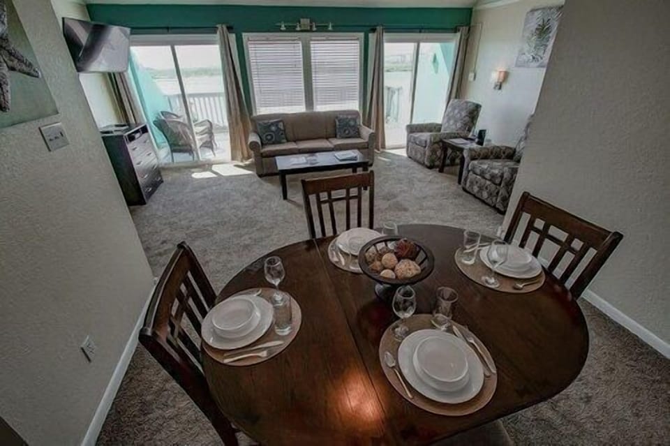 Bright dining space where sunlight pours in, setting the stage for slow breakfasts or cozy dinners after a day by the water.