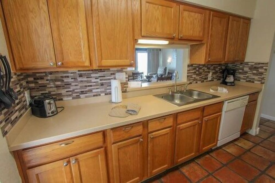Charming kitchen space where the rhythm of island living meets the comfort of home-cooked meals.
