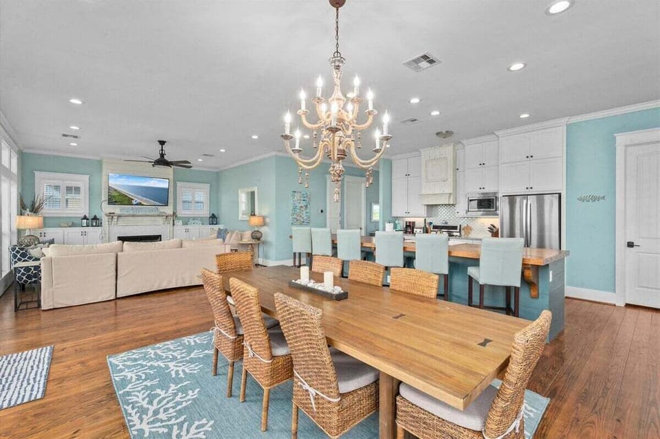 Large dining table with seating for multiple guests, ideal for family meals in beachfront rental