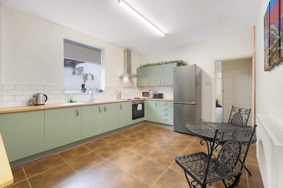 Kitchen equipped with all essentials, including an oven, fridge, and full cookware set.