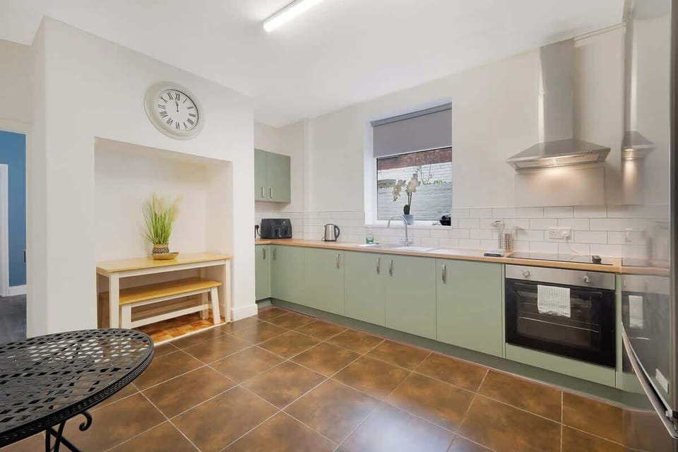 Kitchen equipped with all essentials, including an oven, fridge, and full cookware set.