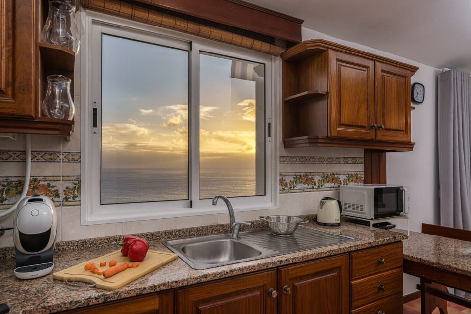 Madeiran kitchen with sunset ocean view.