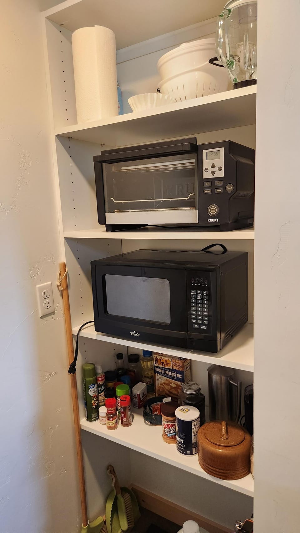 Cozy pantry nook with convenient microwave and storage shelves