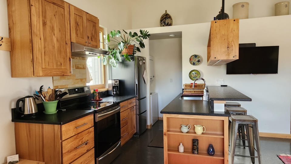 Modern kitchen with warm wood accents and breakfast bar seating