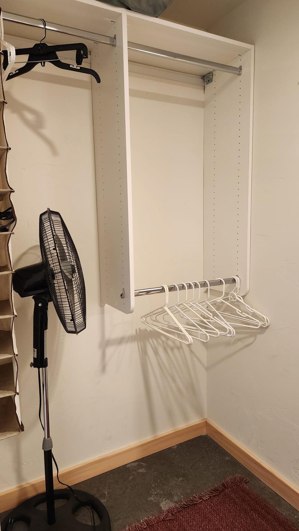 Cozy closet nook with ample hanging space and fan breeze