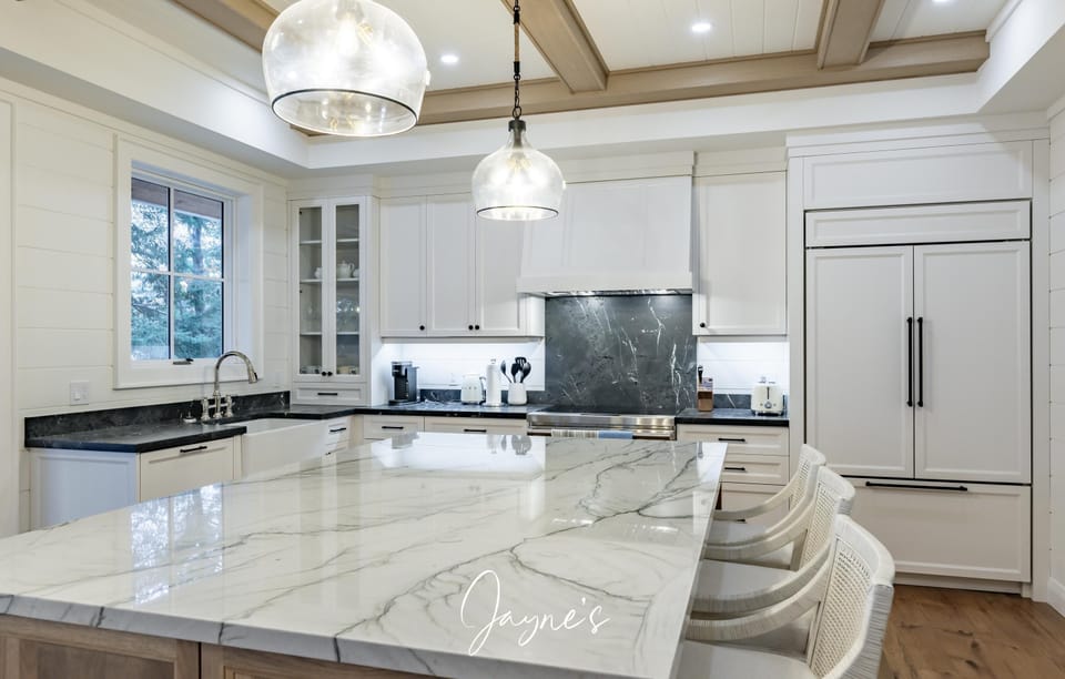 Spacious kitchen with marble island and modern appliances