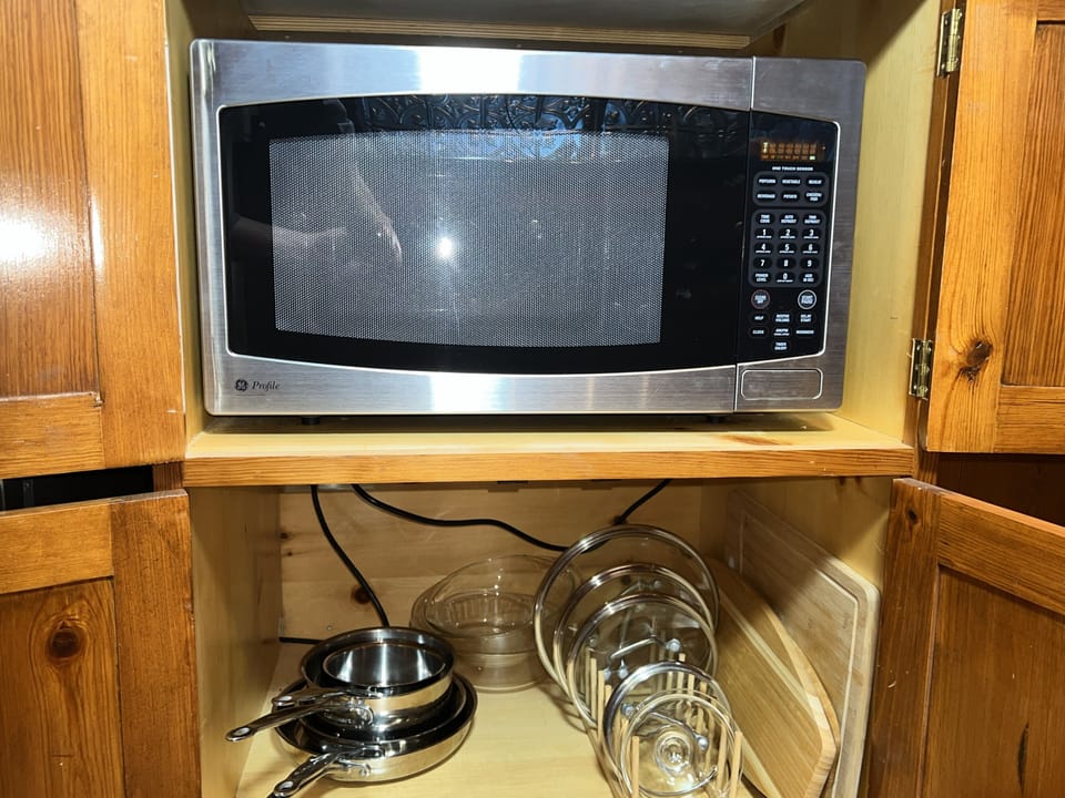 Full size microwave, pots, pans, lids, bowls, and cutting boards