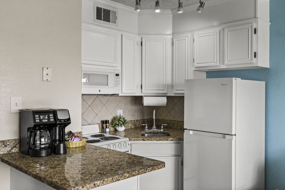 Functional kitchen layout with ample counter space—ideal for quick bites or family meals.