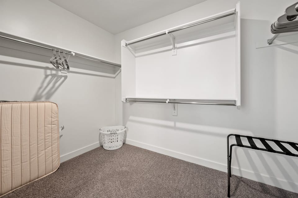 A large walk-in closet offers plenty of space to store your clothes and belongings during your stay.