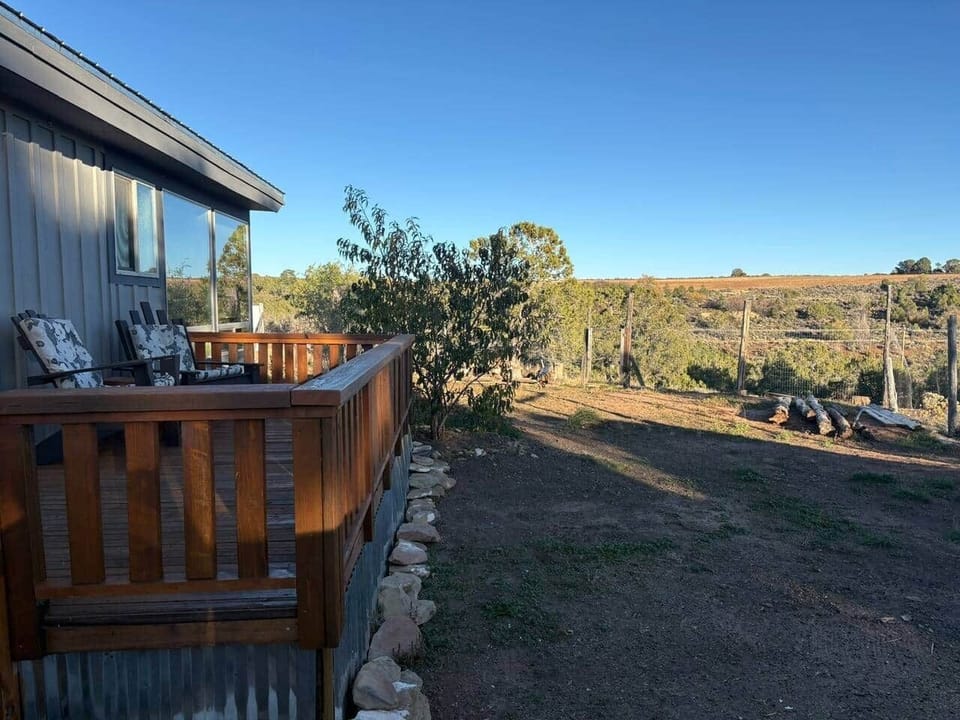 Back deck with a fenced area and view of BML land