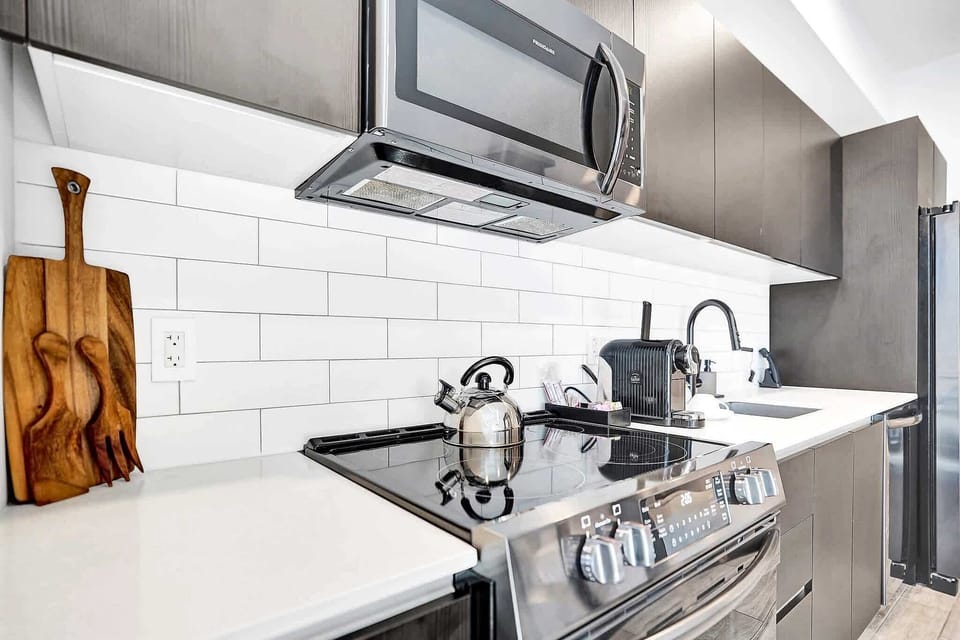 Stainless steel stove with white subway tile backsplash