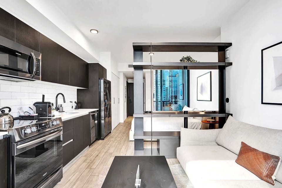 Open-plan studio with sofa and full kitchen