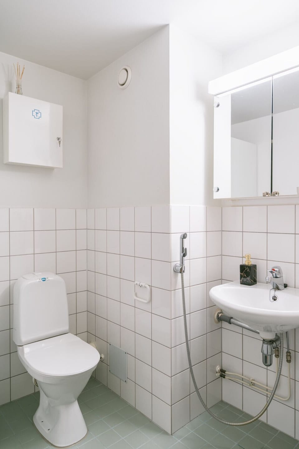 The modern bathroom features a shower, toilet, and washing machine for your convenience.