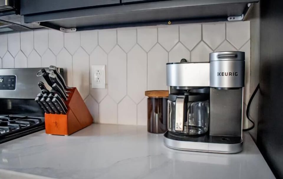 The kitchen is stocked with high quality wares like this Keurig duo coffee maker and Zwilling knife set.