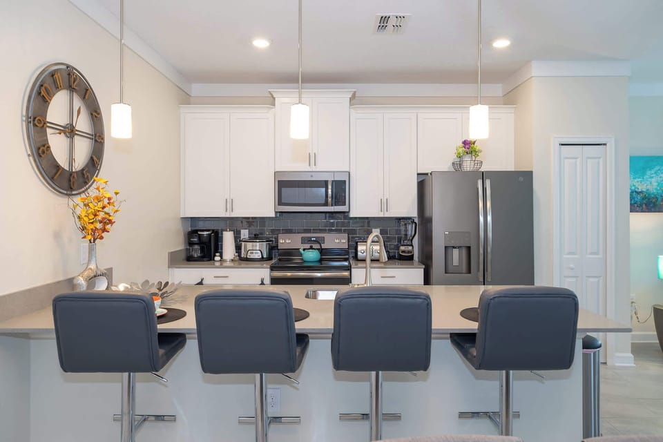 Modern kitchen with a breakfast bar and stainless steel appliances