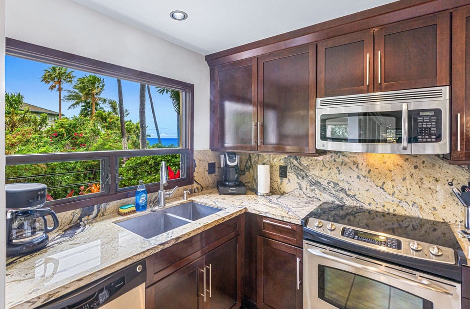 Fully equipped kitchen with stainless steel appliances and ample counter space.