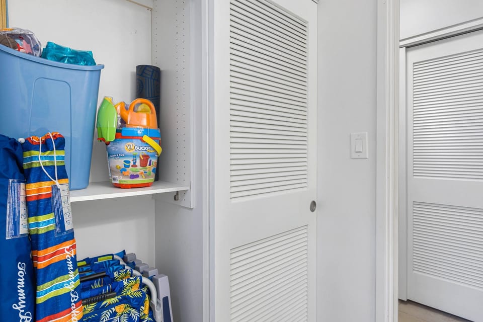 Beach-ready gear neatly arranged in the closet for easy access during your stay.