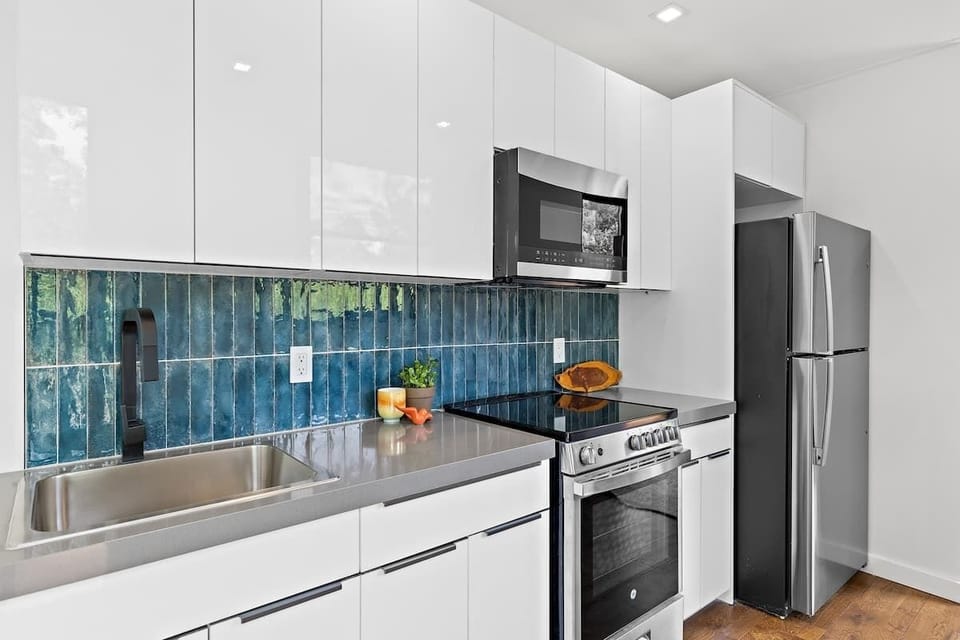 Modern kitchen with everything you need to cook, reheat, or pour wine and pretend.