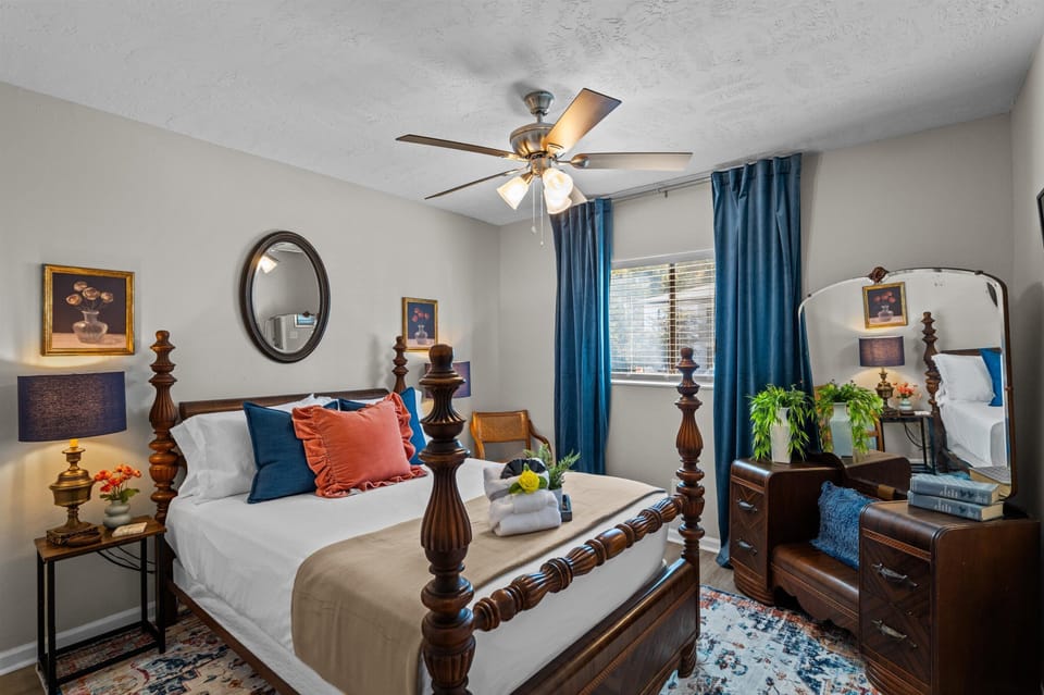 second bedroom with smart TV adjacent to full bathroom