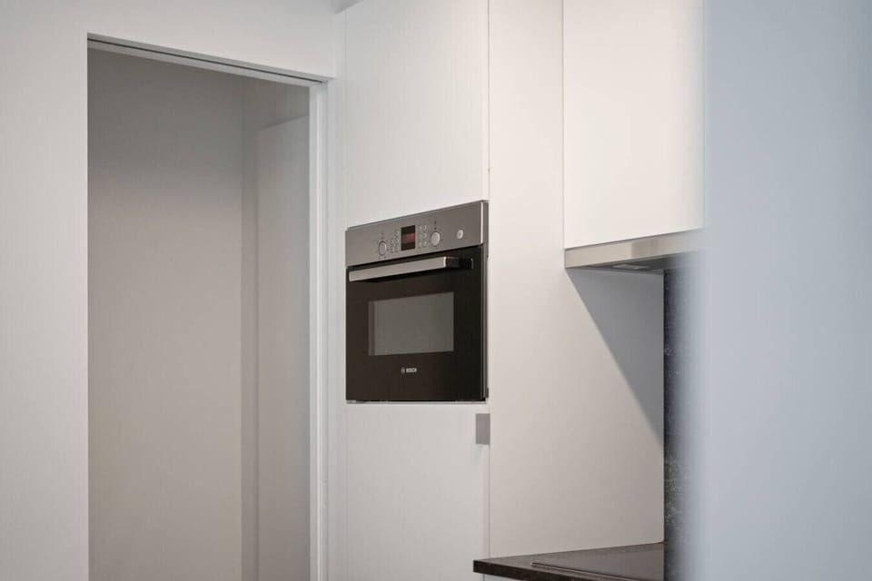 kitchen with combi oven and cooking stove