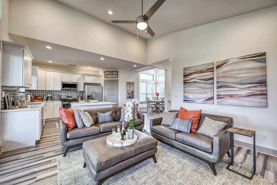 Spacious living area with leather furnishings and a warm, inviting style.
