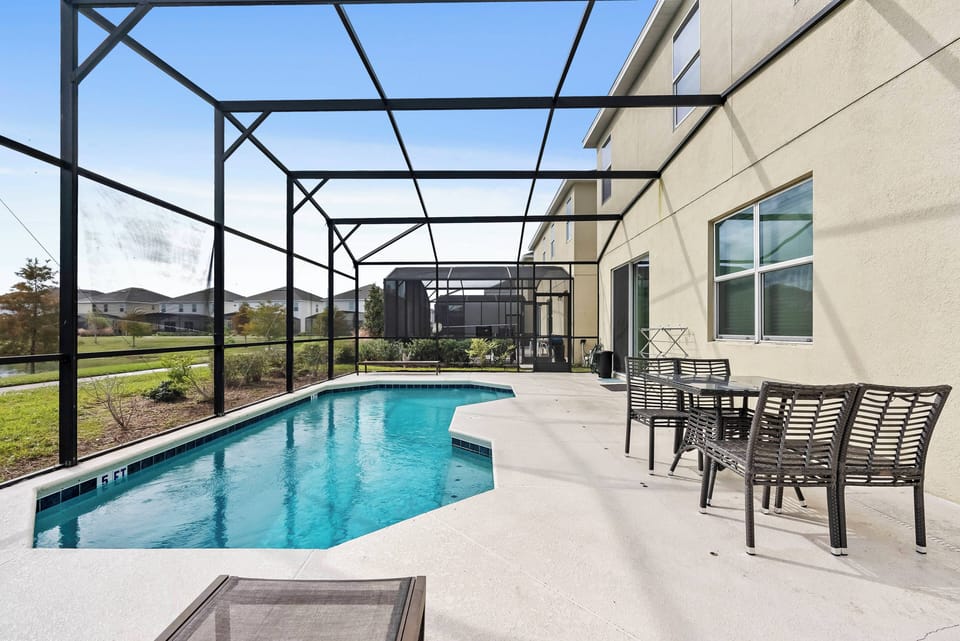 Step outside to your private oasis with a sparkling blue pool and spacious patio ideal for lounging. Enjoy sleek furniture, soak up the sun, and feel the comfort and tranquility of the screened enclosure.