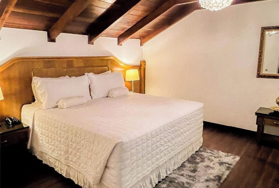 Stretch out in crisp bedding beneath warm, vaulted wood ceilings.