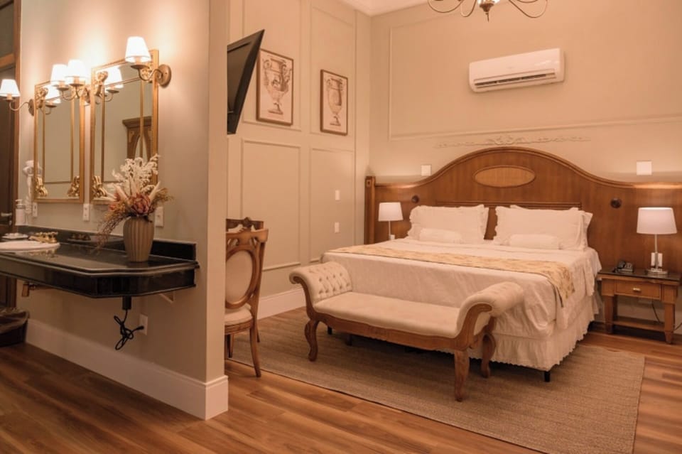Unwind in a refined suite with plush bedding and warm lighting.