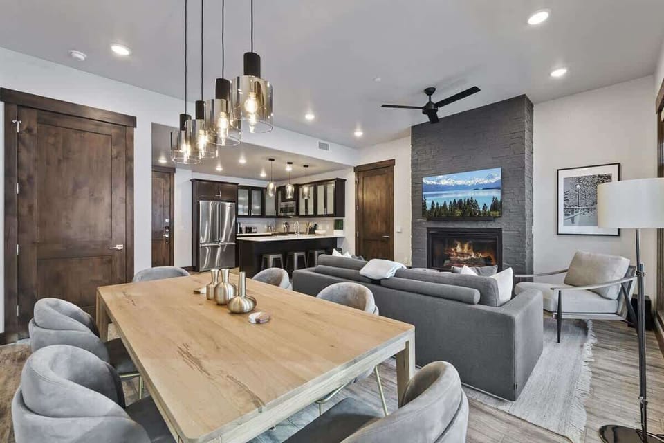Open floor plan with dining table, living area, and kitchen.