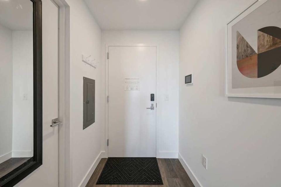 View of front door with bathroom on left