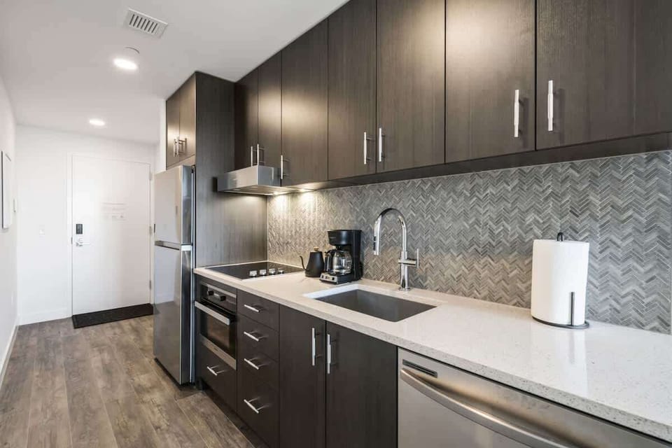 Modern kitchen with fridge, freezer, dishwasher, over and stop top