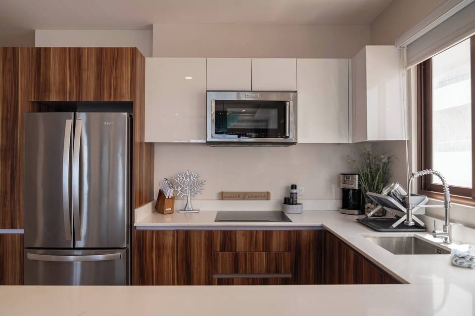 Whip up delicious meals in this sleek, modern kitchen, fully equipped for your culinary adventures.