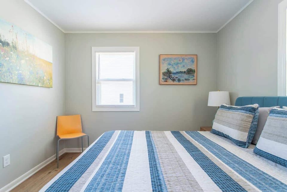 Queen Bedroom: Relax in style with bright art & a comfy queen bed.