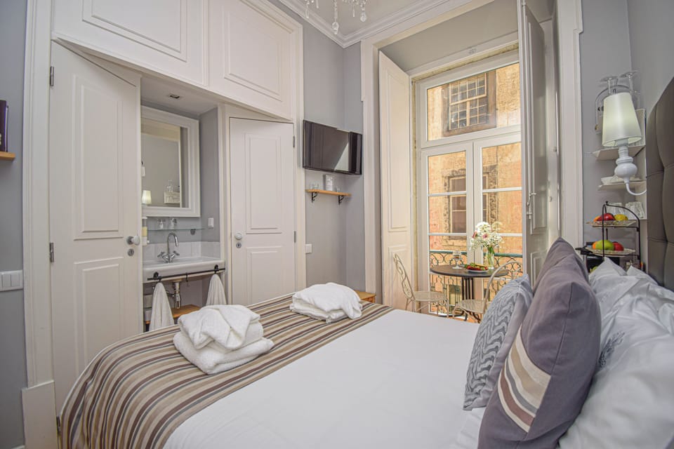 Suite, Balcony, City View | Minibar, in-room safe, soundproofing, iron/ironing board