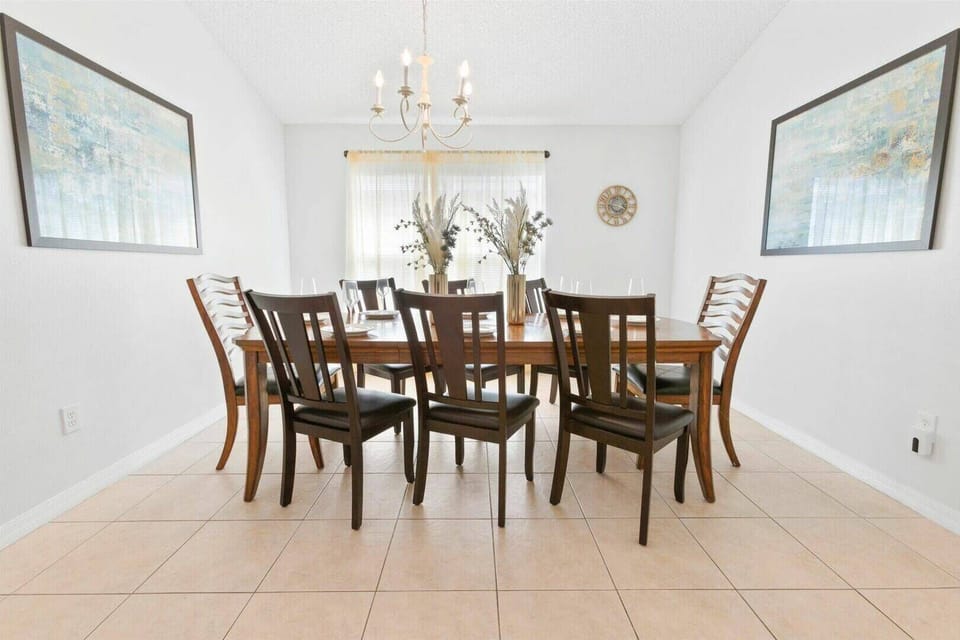 This bright and airy dining area invites you to create lasting memories with loved ones. The warm wooden table and elegant dark chairs offer a cozy yet refined atmosphere, beautifully illuminated by a stylish chandelier.