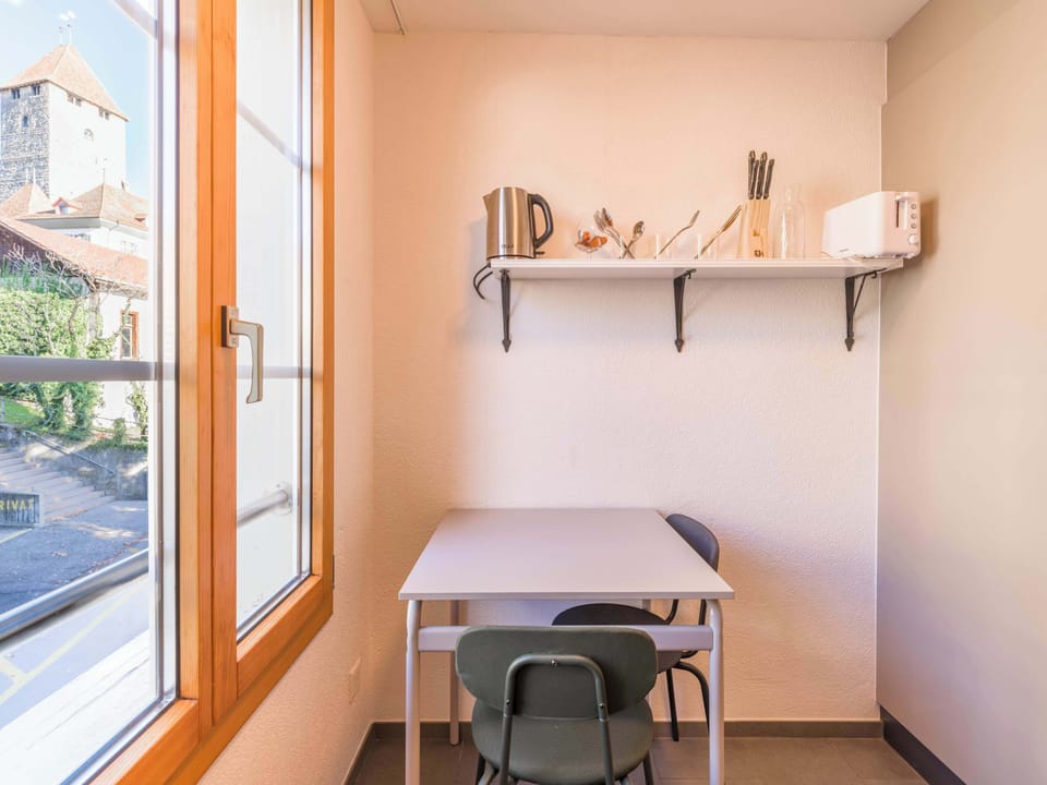 Second small dining area by the window with natural light
