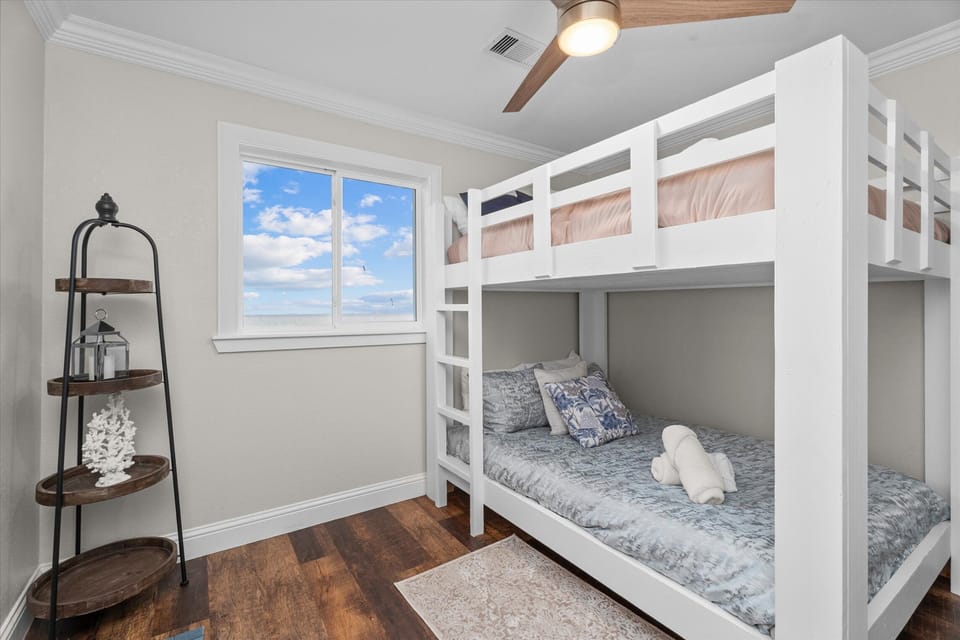 Spacious bunk bedroom with multiple sleeping arrangements for large groups.