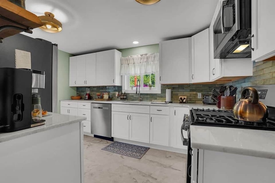 Stock up & spread out — plenty of cabinets, a teapot & dishwasher make life easy.
