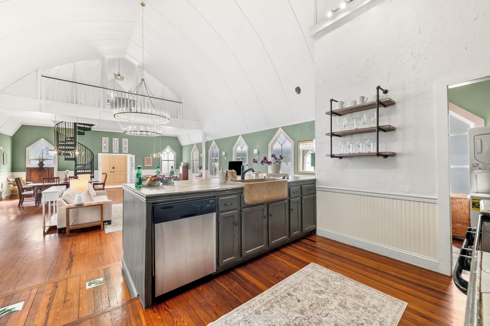 Spacious, bright kitchen: modern stainless steel appliances and large island.
