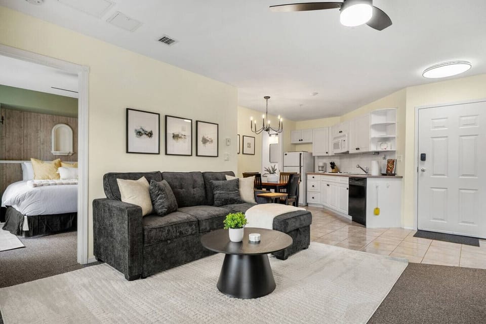 Living room with a gas-lit fireplace, smart TV, board games, walkout access to the balcony and a luxurious couch with a sleeper sofa (all bedding provided.)
