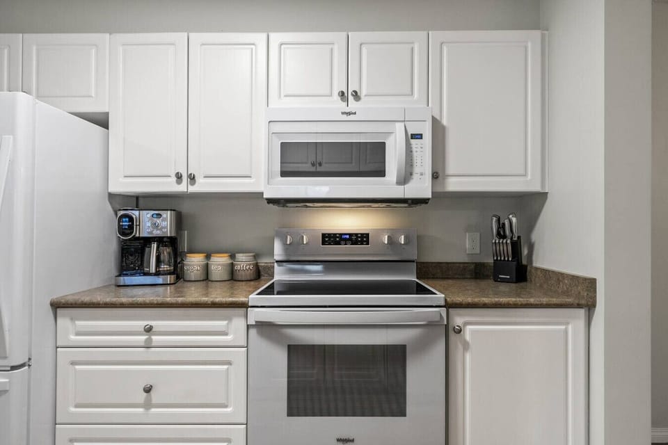 Full kitchen with a drip & Keurig coffee machine, blender, instant pot, slow cooker, rice cooker and a hand mixer.