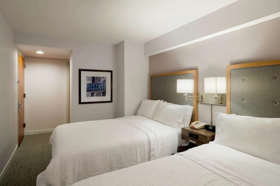 Bright guest room with twin beds and framed wall art