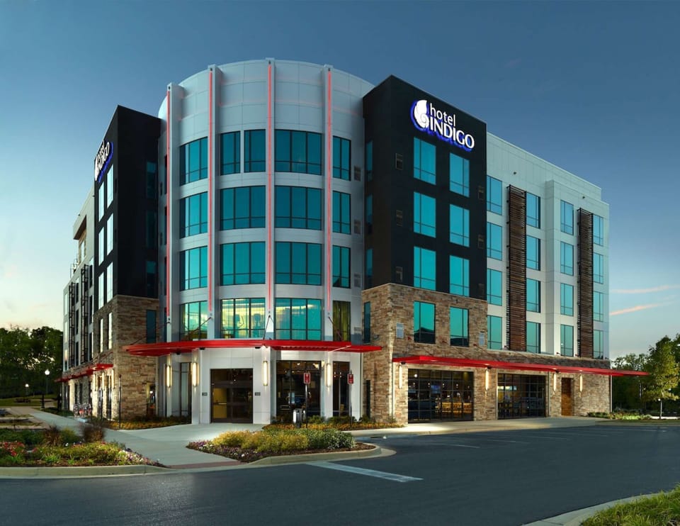 Property exterior with red accents and large blue windows