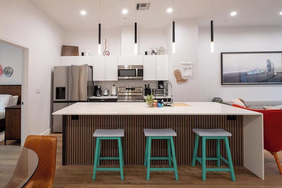 Open modern kitchen concept with tall ceilings and stocked with everything you need to cook with