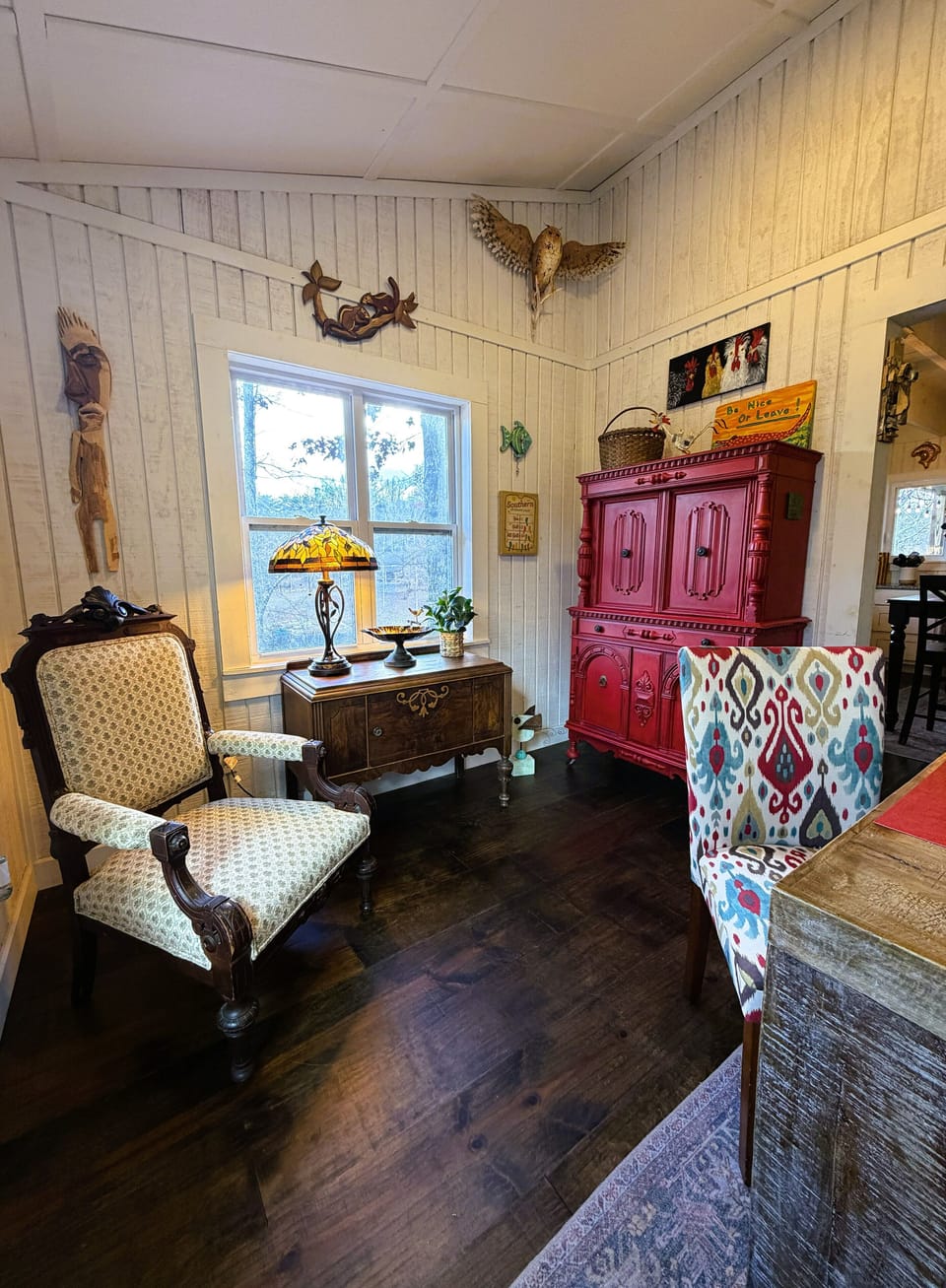 Explore the red cabinet to find a fun game or puzzle or read in the cozy chair.