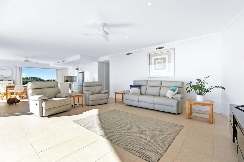Comfortable, light-filled living area featuring recliner seating and direct outdoor access.
