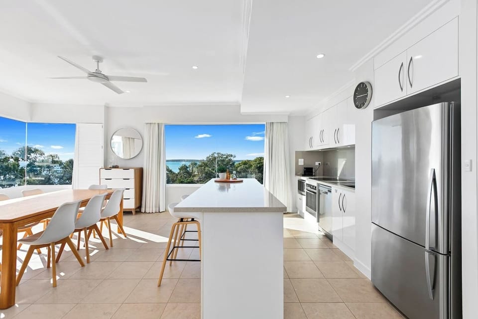 Fully equipped white kitchen and dining area