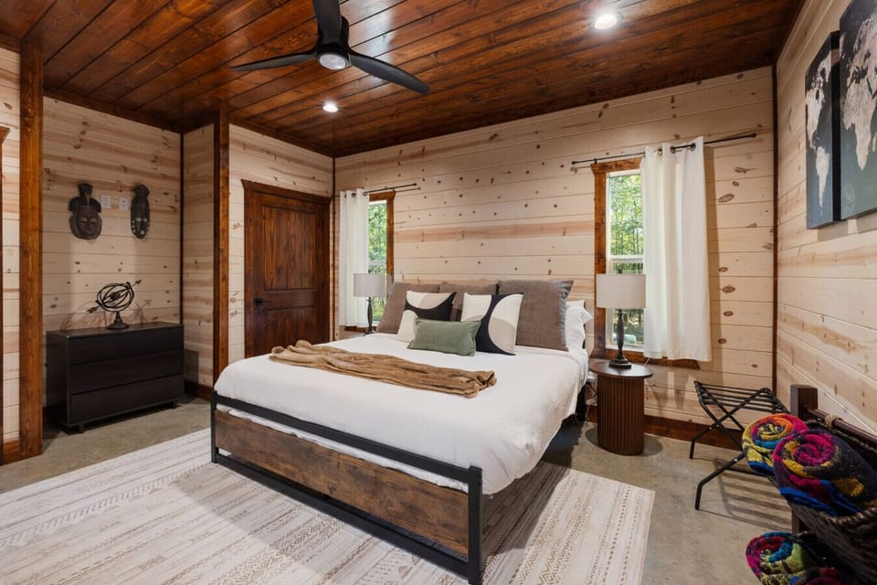 Spacious king bedroom with ceiling fan, dresser, and room to unpack, so longer stays feel organized, comfortable, and more like your own private retreat in Broken Bow