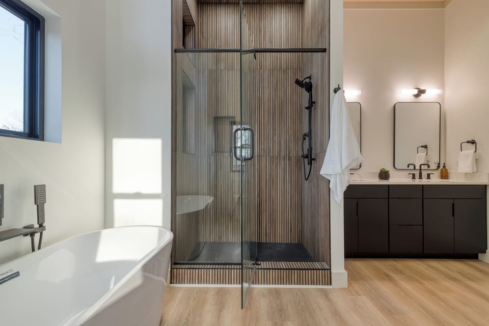 The primary bedroom's ensuite features a soaking tub and a shower.
